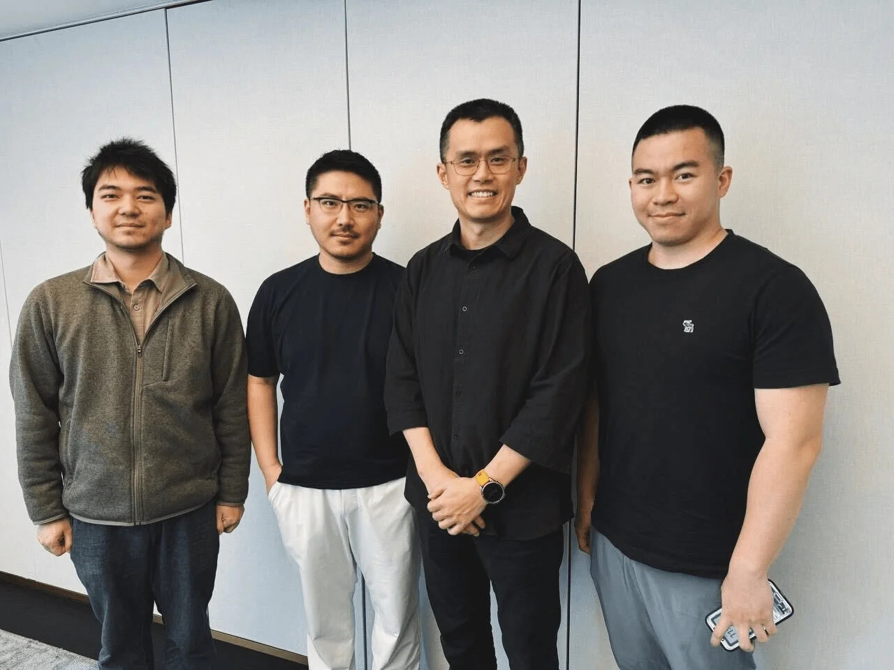 OneKey CTO, CEO, and COO pictured with CZ. 